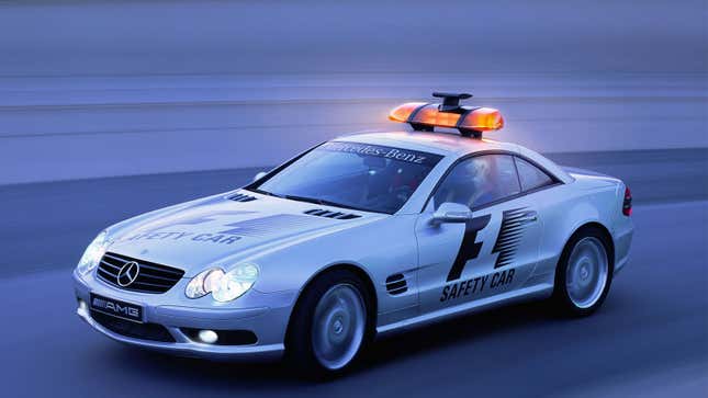 A silver Mercedes-Benz safety car with lights on its roof. 