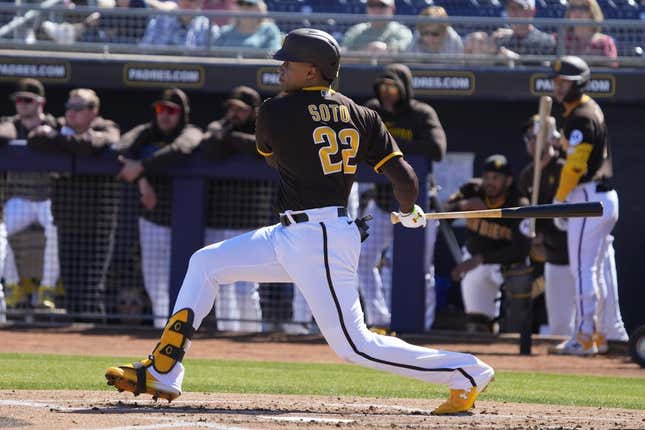 Feb 24, 2023; Peoria, Arizona, USA; San Diego Padres right fielder Juan Soto (22) hits a single against the Seattle Mariners in the first inning at Peoria Sports Complex.