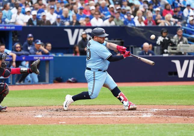 Aug 30, 2023; Toronto, Ontario, CAN; Toronto Blue Jays catcher Alejandro Kirk (30) hits an RBI sacrifice fly ball against the Washington Nationals during the seventh inning at Rogers Centre.
