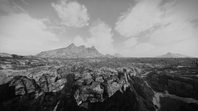 A screenshot shows a black and white landscape of a planet in Starfield, with a mountain range in the background.