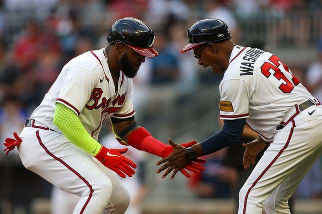 May 25, 2023;  Atlanta, Georgia, USA;  Atlanta Braves designated hitter Marcell Ozuna (20) celebrates with third-base coach Ron Washington (37) after the home game against the Philadelphia Phillies in the second inning at Truist Park.