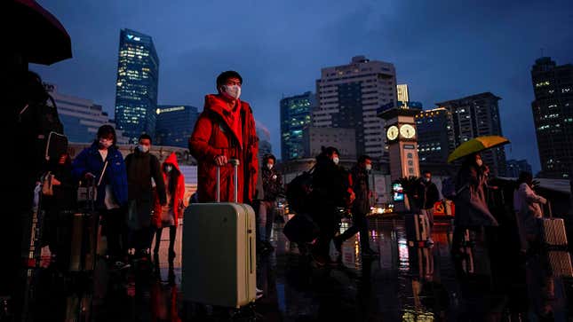 People wearing protective masks walk at the Shanghai Railway Station, as the annual Spring Festival travel rush begins ahead of the Chinese Lunar New Year, following new cases of the coronavirus disease (COVID-19), in Shanghai, China January 27, 2022. REUTERS/Aly Song