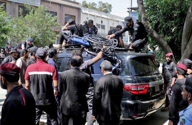 Pakistan security forces protect a vehicle carrying former prime minister Khan after his arrest in Islamabad.