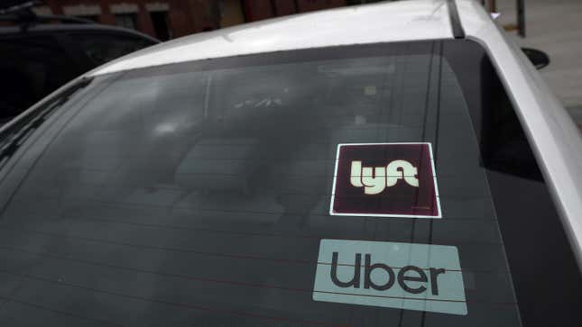 Windshield displaying Lyft and Uber decals