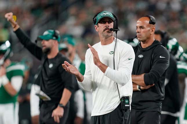 New York Jets quarterback Aaron Rodgers, center, and head coach Robert Saleh, right, on the sideline during a preseason NFL game against the Tampa Bay Buccaneers at MetLife Stadium on Saturday, Aug. 19, 2023, in East Rutherford.