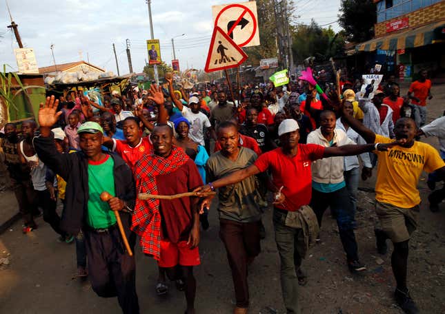 Supporters of Kenyan opposition leader Raila Odinga gesture and chant slogans as they walk along a street in Humura neighbourhood, in Nairobi, Kenya.