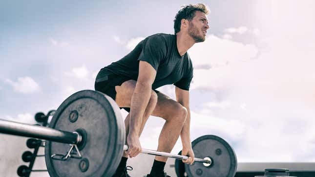 Man concentrating on lifting heavy weight