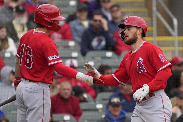 Mar 22, 2023; Salt River Pima-Maricopa, Arizona, USA; Los Angeles Angels first baseman Jared Walsh (20) celebrates after hitting a solo home run against the Colorado Rockies with center fielder Mickey Moniak (16) in the second inning at Salt River Fields at Talking Stick.