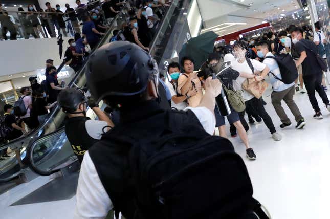 Plainclothes police officers use pepper spray to disperse protesters inside a mall in Hong Kong, July 14, 2019.