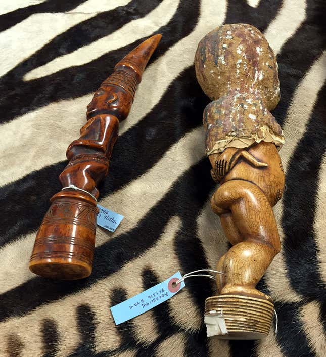 Two ivory statues; one is partially hidden inside papier-mâché.
