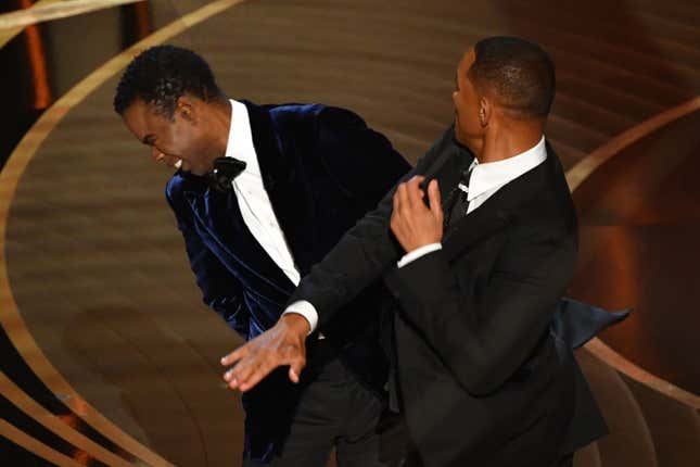 Will Smith, right slaps US actor Chris Rock onstage during the 94th Oscars at the Dolby Theatre in Hollywood, California on March 27, 2022.