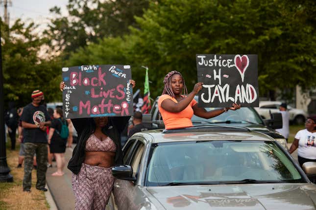 Demonstrators hold signs during a vigil in honor of Jayland Walker on July 8, 2022 in Akron, Ohio. Walker was shot and killed by members of the Akron Police Department on July 3, 2022. 