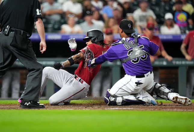 Aug 15, 2023; Denver, Colorado, USA; Colorado Rockies catcher Elias Diaz (35) tags out Arizona Diamondbacks second baseman Ketel Marte (4) in the seventh inning at Coors Field.