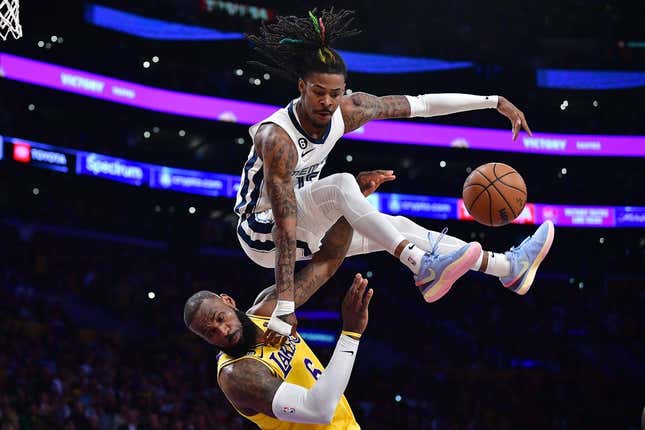 Apr 24, 2023; Los Angeles, California, USA; Memphis Grizzlies guard Ja Morant (12) collides with Los Angeles Lakers forward LeBron James (6) while moving to the basket during the second half in game four of the 2023 NBA playoffs at Crypto.com Arena.