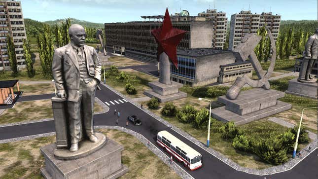 A Lenin statue looms over a city in a screenshot from Workers & Resources: Soviet Republic.