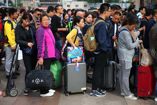 Chinese passengers line up to buy tickets at the Beijing Railway Station on Sept. 27, 2016 before the seven-day Chinese National Day holiday.
