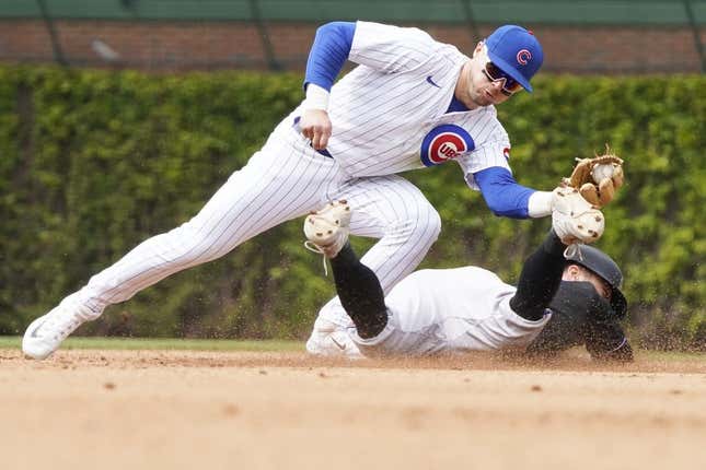 May 6, 2023; Chicago, Illinois, USA; Chicago Cubs second baseman Nico Hoerner (2) tags out Miami Marlins shortstop Jon Berti (5) at second base on a steal attempt of second base during the fifth inning at Wrigley Field.