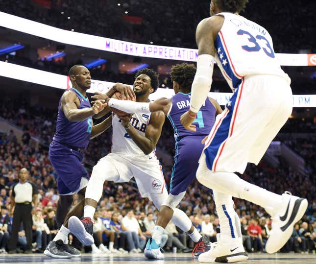 Philadelphia 76ers and Cameroon’s Joel Embiid (21) drives to the ball to the basket as Charlotte Hornets and DR Congo’s Bismack Biyombo (8) and Devonte Graham (4) defend.
