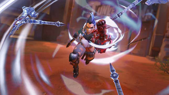 A character in Overwatch 2 raises toward the camera while swirling magical hammers surround them.