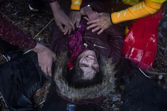 A woman reacts after her arrival in bad weather on Wednesday, Oct. 28, 2015.