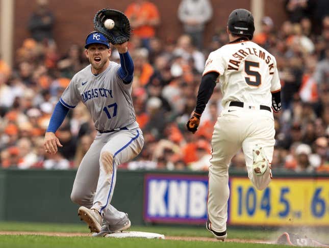 Apr 7, 2023; San Francisco, California, USA; Kansas City Royals first baseman Hunter Dozier (17) takes the relay in time to retire San Francisco Giants center fielder Mike Yastrzemski (5) on a bunt attempt during the sixth inning at Oracle Park.