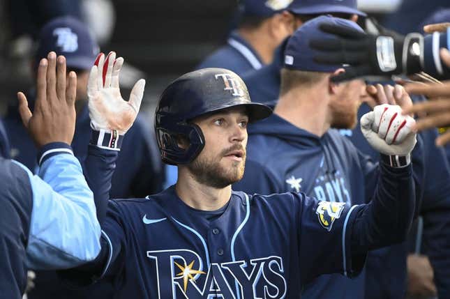 Apr 27, 2023; Chicago, Illinois, USA; Tampa Bay Rays second baseman Brandon Lowe (8) celebrates in the dugout after scoring against the Chicago White Sox during the second inning at Guaranteed Rate Field.