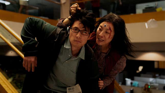 Michelle Yeoh's Eveyln Wang grapples the hair of a male assailant in Everything, Everywhere, All at Once
