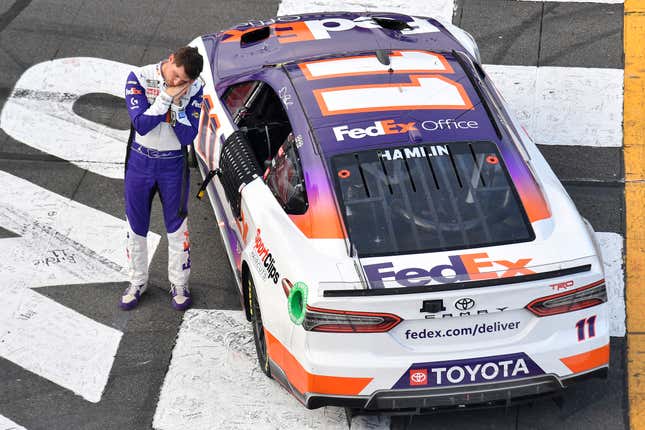 Denny Hamlin, driver of the No. 11 FedEx Office Toyota, gestures after winning the NASCAR Cup Series M&amp;M’s Fan Appreciation 400 at Pocono Raceway on July 24, 2022 in Long Pond, Pennsylvania.