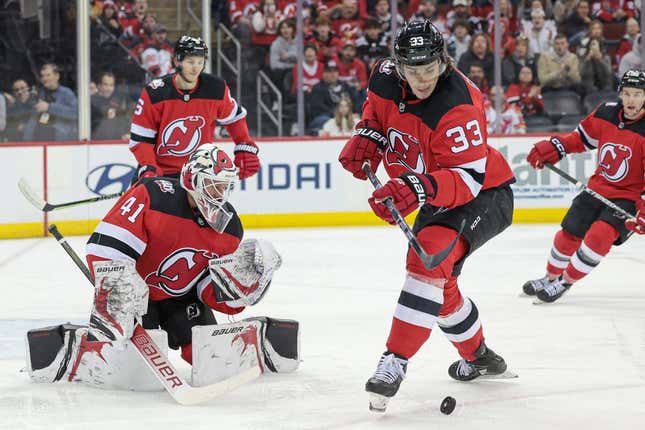 Mar 12, 2023; Newark, New Jersey, USA; New Jersey Devils defenseman Ryan Graves (33) clears the puck in front of goaltender Vitek Vanecek (41) during the first period against the Carolina Hurricanes at Prudential Center.