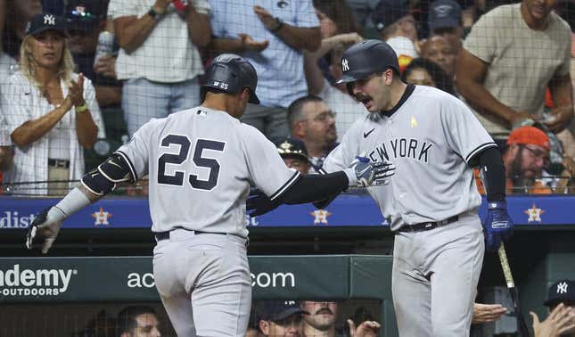 Sep 3, 2023; Houston, Texas, USA; New York Yankees second baseman Gleyber Torres (25) celebrates with catcher Austin Wells (88) after hitting a home run during the ninth inning against the Houston Astros at Minute Maid Park.