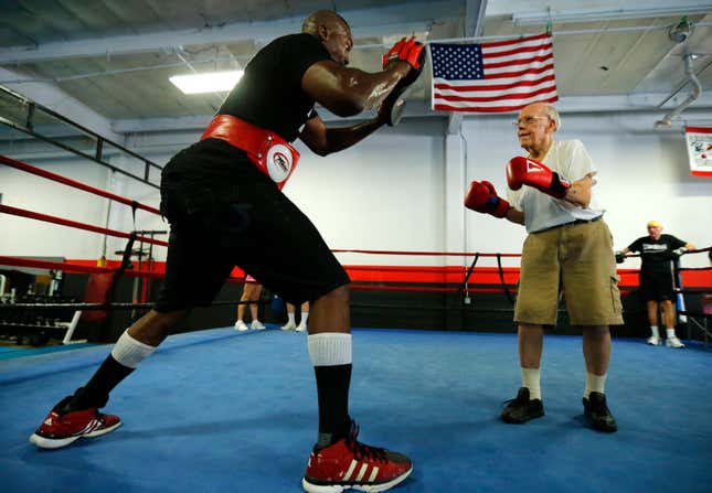 Parkinson’s patient Jim Coppula works out in the ring with boxing coach Justice Smith