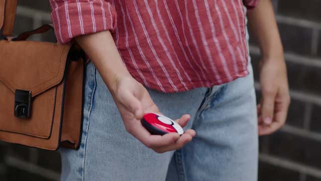 A photo of a person carrying the Pokemon Go Plus+