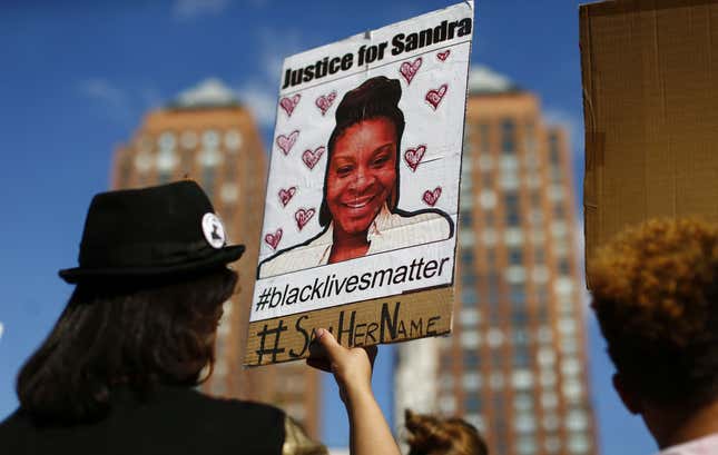 A woman holds a poster bearing the portrait of Sandra Bland, a 28-year-old black woman who killed herself in a Texas jail cell on July 13th, during a Michael Brown memorial rally on Union Square August 9, 2015 in New York.