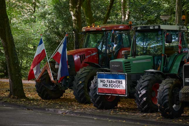 Tractors with protest signs parked on the outskirts of The Hague