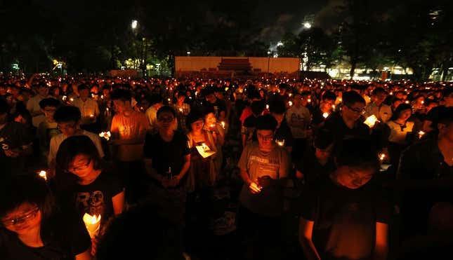 Participant mourn those killed during June 4th military crackdown on pro-democracy movement in Beijing, at Hong Kong's Victoria Park