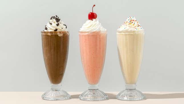 Chocolate, strawberry, and vanilla milkshake on counter