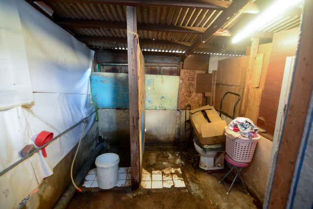 A makeshift toilet in a Hong Kong refugee shack.