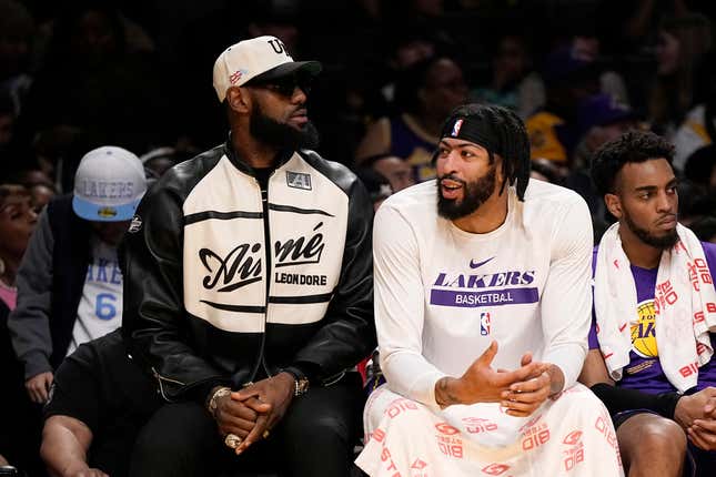 LeBron James (l.) and Anthony Davis chat as they sit on the bench during the first half of a recent Lakers-Thunder game.