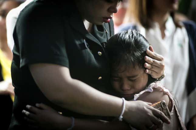 A child cries for the death of the King of Thailand. (AP Photo/Wason Wanichakorn)