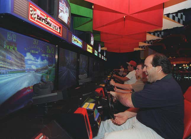 This photo was taken in 2001 at an arcade at the Ontario Mills Mall in California. Daytona USA may be almost 30 years old, but you can still find cabinets in arcades across North America today. These wide-screen “Deluxe” installations have become rare, though.
