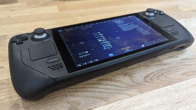 The Steam Deck playing Stellaris, on a wooden table.