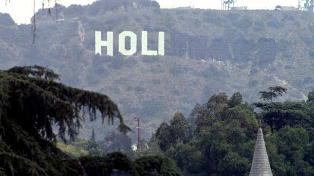 The Hollywood sign is obscured to read "HOLI" with the rest of the letters blacked out