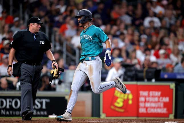 Aug 19, 2023; Houston, Texas, USA; Seattle Mariners center fielder Julio Rodriguez (44) crosses home plate to score a run against the Houston Astros during the eighth inning at Minute Maid Park.