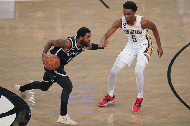Brooklyn Nets’ Kyrie Irving, left, drives against New Orleans Pelicans’ Herbert Jones during the first half of an NBA basketball game Wednesday, Oct. 19, 2022, in New York.