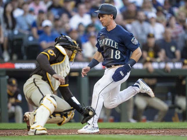 Aug 9, 2023; Seattle, Washington, USA; Seattle Mariners left fielder Cade Marlowe (18) scores a run against San Diego Padres catcher Luis Campusano (12) during the third inning at T-Mobile Park.