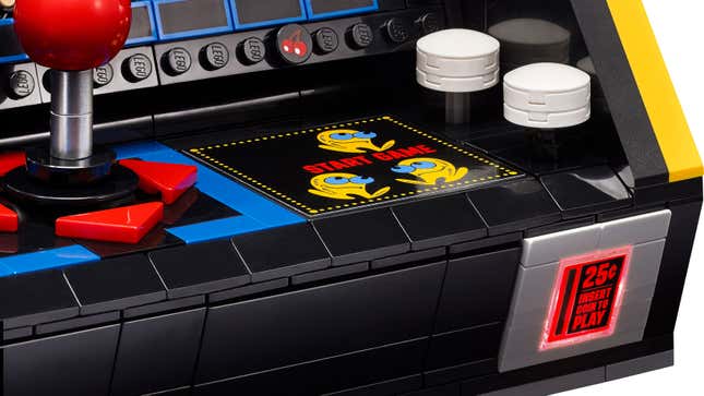 A close-up of nan 'Start Game' buttons and illuminated coin slot connected nan Lego Pac-Man Arcade Machine Set.