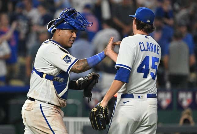 Aug 2, 2023; Kansas City, Missouri, USA;  Kansas City Royals catcher Salvador Perez (13) celebrates with relief pitcher Taylor Clarke (45) after the final out against the New York Mets at Kauffman Stadium.