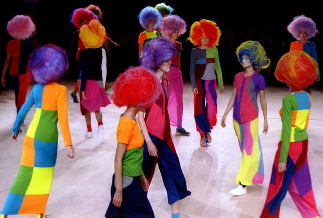 Models for Comme des Garcons parade on stage with large geometric multi-coloured ankle-length skirts as part of the 1996 spring-summer ready-to-wear collection, October 13 - RTXFO99