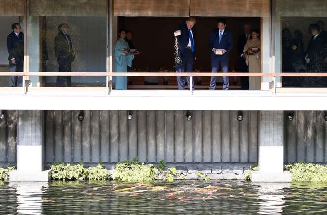Trump and Abe feed carp at Akasaka Palace in Tokyo, Japan, Nov. 6 2017.