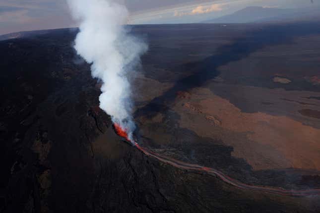In an aerial view, lava shoots up from a fissure of Mauna Loa Volcano as it erupts on December 05, 2022 in Hilo, Hawaii.